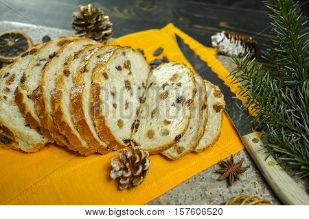 Fresh baked raisins bread sliced on granite board holiday concept