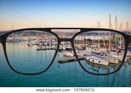 Clear image in glasses against blurry landscape