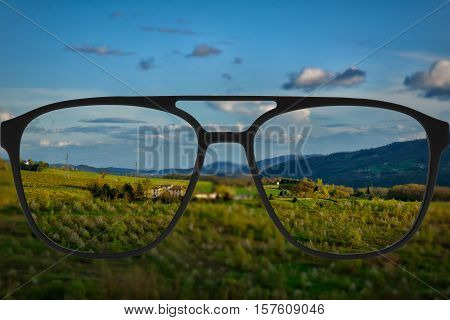 Clear image in glasses against blurry landscape