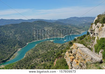A Limestone Slabs Are On The Top Of Cliff Above The River Embalsa With The Artificial Lake In The Gr