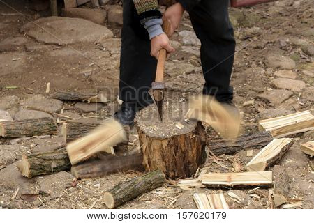 Man chopping fire wood with motion blur