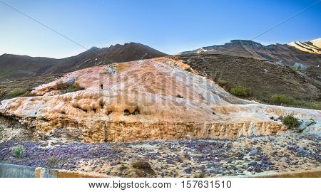 Mineral water stream covered the slope with travertine deposits, Cross Pass, Gudauri, Georgia. Europe.