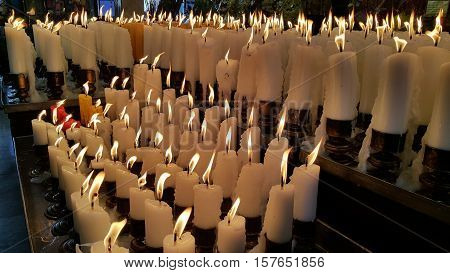 The white candles lit up in the shrine.