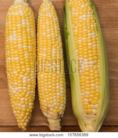 Corn on the cob on a wooden background