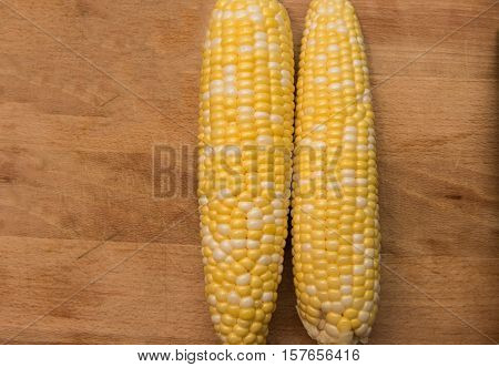 Corn on the cob on a wooden background