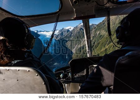 Passengers in a helicopter as it approaches the Franz Josef Glacier in New Zealand