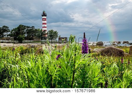 Shepelevsky Cape.Russia.26 Jun 2016.Shepelevsky lighthouse on the Gulf of Finland in the Leningrad region with a rainbow after the rain