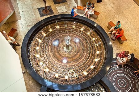 Krakow Poland - June 07 2011: People shoppers gathered at Galeria Krakowska fountain. Galeria Krakowska has 270 specialty shops cafes and restaurants