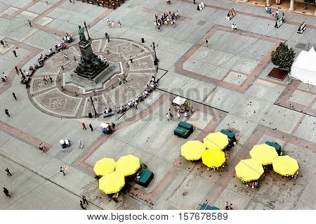 Krakow Poland - June 07 2011: Top view of the Main Square with monument to Adam Mickiewicz. Krakow has been awarded a number of top international rankings such as the 1st place in the Top city-break destinations.