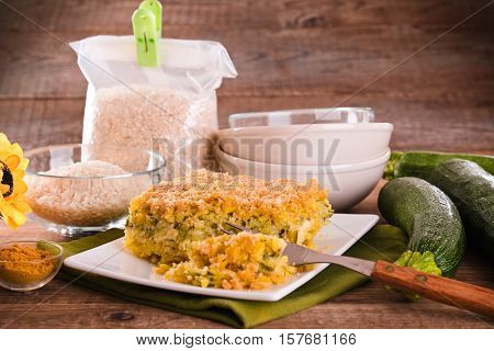 Rice timbale with zucchini on white dish.