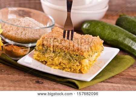 Rice timbale with zucchini on white dish.