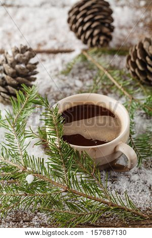 Mug With A Hot Drink And With A Fir-cone On A Wooden Stump In The Snow In The Outdoors