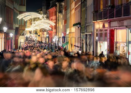 Large crowd of people hustling and shopping in a pedestrian area in Heidelberg Germany for Christmas