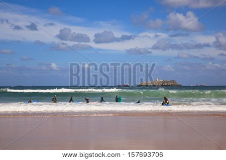 SANTANDER SPAIN - AUGUST 20: Boys teen surfing in Cantabrian sea on August 20 2016