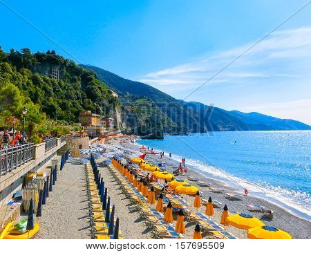Monterosso, Italy - People on the coastline of Monterosso in Italy. Monterosso is one of five famous coastline villages in the Cinque Terre National Park.