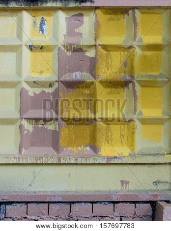 Concrete fence roughly two stained paint colors