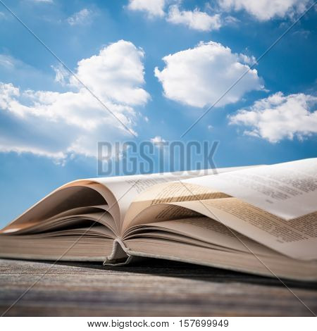 book open read legal wisdom novel sky cloud life background light old space wooden concept page religion blue concept - stock image