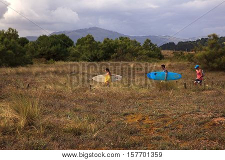 SANTANDER SPAIN - AUGUST 20: Surfer people carrying their surfboard on August 20 2016