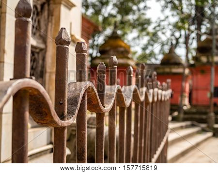 Repeating pattern fence tops outside of p Nepal temp.e