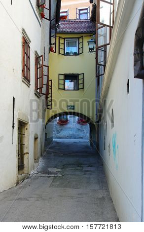 Gmina Škofja Loka, Škofja Loka Slovenia - September 25 2016: old town, Klobovsova Street. Typical buildings, windows decorated with flowers.