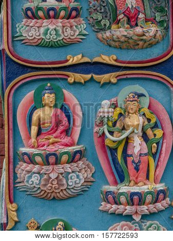 Colorful carved religious symbols Nepali building exterior