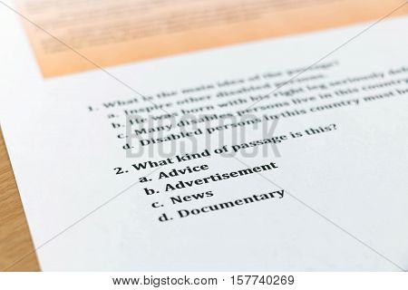 english reading test sheet on wooden table