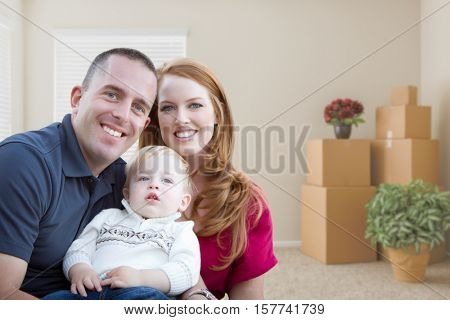 Happy Young Military Family in Empty Room with Packed Boxes and Plants.
