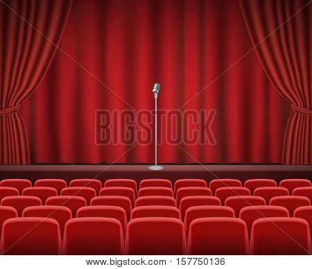 Rows of red cinema or theater seats in front of show stage with retro microphone