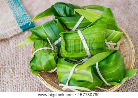 Traditional Thai food style Thai dessert made from banana and glutinous rice wrap with pandan (Khao Tom Mat)