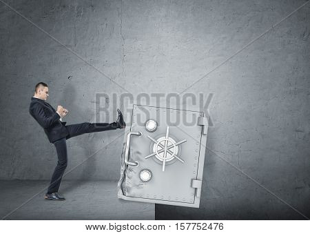 A businessman kicking a deformed safety box to throw it down in the pit. Business development and the way to success. Issues in business management and economics. Resolving the problems.
