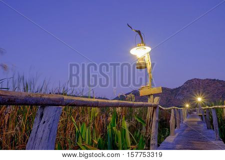 the lamp on the wood bridge go to the lake and mountain