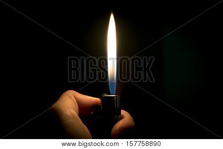 Lighter on the hand in the dark.