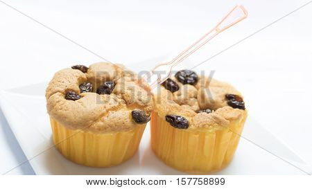 A Cup cake with currant are delicious.