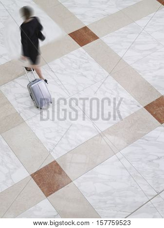 Woman out of focus walking through a lobby