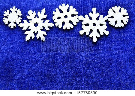 Christmas decoration.Snowflakes border on blue background with copyspace.Christmas snowflakes.Snowflakes background.Top view.Winter holidays,Christmas or Happy New Year concept.