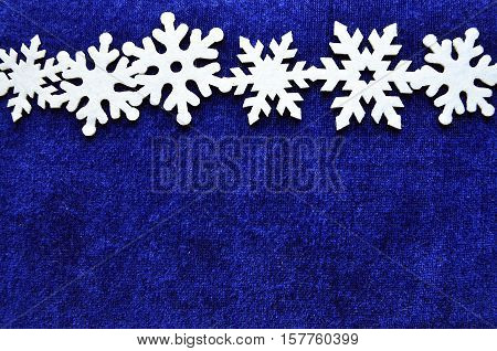 Snowflakes border on blue background with copyspace.Christmas snowflakes.Snowflakes background.Top view.Winter holidays,Christmas or Happy New Year concept.