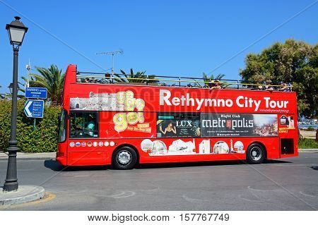 RETHYMNO, CRETE - SEPTEMBER 15, 2016 - Tourists aboard a red open topped Rethymno City Tour bus Rethymno Crete Greece Europe, September 15, 2016.