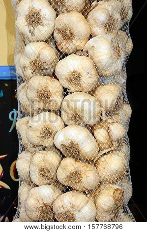 Garlic bulbs hanging in a net sack outside a restaurant Rethymno Crete Greece Europe.
