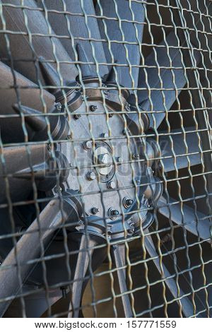 Closeup of the air screw blades from a snow cannon with protection grid in front