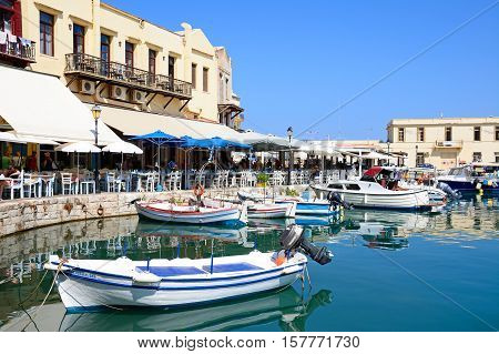 RETHYMNO, CRETE - SEPTEMBER 15, 2016 - View of boats and waterfront restaurants in the inner harbour Rethymno Crete Greece Europe, September 15, 2016.