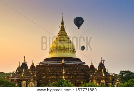 Dhammayazika pagoda in Bagan. Dhammayazika pagoda gilded with Bagan gold located east of Bagan, Mandalay, Myanmar. Natural light, soft focus due to long exposure.