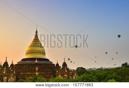 Dhammayazika pagoda in Bagan. Dhammayazika pagoda gilded with Bagan gold located east of Bagan, Mandalay, Myanmar. Natural light, soft focus due to long exposure.