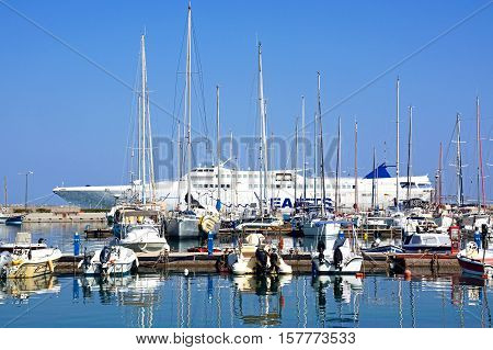 RETHYMNO, CRETE - SEPTEMBER 15, 2016 - Boats and yachts moored in the marina with a high speed passenger ferry to the rear Rethymno Crete Greece Europe, September 15, 2016.