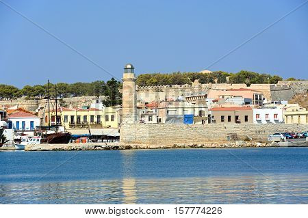 RETHYMNO, CRETE - SEPTEMBER 15, 2016 - View of the harbour and lighthouse with the castle to the rear Rethymno Crete Greece Europe, September 15, 2016.