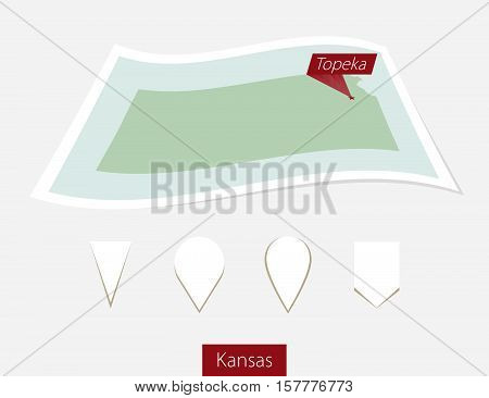 Curved Paper Map Of Kansas State With Capital Topeka On Gray Background. Four Different Map Pin Set.
