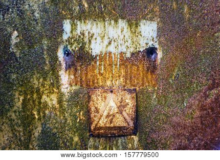 Old rusty tin surface with warning sign of high voltage for background
