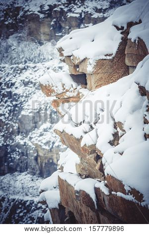 Rocks large granite stones covered with snow filter natural background
