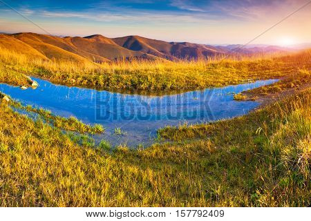 Colorful Autumn Morning In The Carpathian Mountains With Big Puddle