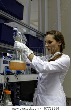 ST. PETERSBURG, RUSSIA - NOVEMBER 16, 2016: Researcher analyses the culture fluid in the High-Throughput Biotechnology Laboratory of BIOCAD, the full-cycle drug development and manufacturing companies