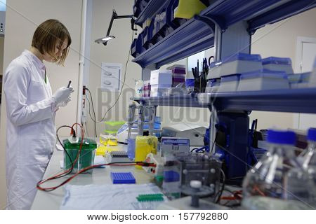ST. PETERSBURG, RUSSIA - NOVEMBER 16, 2016: Researcher at work in the High-Throughput Biotechnology Laboratory of BIOCAD. It is one of the few full-cycle drug development and manufacturing companies